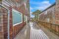 Your private deck offers peaceful outdoor space with seating, surrounded by charming coastal architecture.
