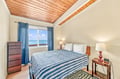 Wake up to the calming sound of waves and stunning ocean views framed by your bedroom window. The vaulted wood ceiling adds warmth and character to your serene coastal retreat.