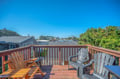 Soak up sunshine on your private deck with comfortable seating overlooking the peaceful neighborhood.