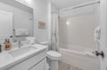 Your pristine bathroom features a relaxing tub-shower combo with fresh towels and thoughtful amenities waiting for your arrival.