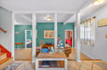 Your bright beach house living room awaits with coastal charm, turquoise accents, and nautical touches that instantly put you in vacation mode.