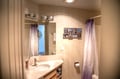 Step into your private bathroom with modern fixtures, warm lighting, and coastal-inspired decor. Fresh towels and a spotless vanity await your arrival.