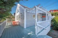 Charming coastal cottage with wraparound deck and pergola creates your perfect seaside retreat for morning coffee and sunset views.