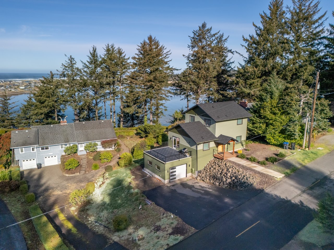 Waterfront property nestled among towering evergreens with stunning bay views and peaceful residential setting.