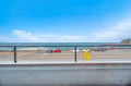 Ocean views stretch endlessly beyond the coastal road, where beach access and parking create the perfect seaside escape.