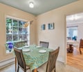 Gather around this charming dining table set by a bright window, where your morning coffee and evening meals become moments to savor together.