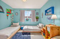 Your kids will love this cheerful common area with twin beds, colorful ocean-themed decor, and plenty of space to play and dream.