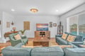 Sink into plush coastal furnishings and unwind in your bright living space with nautical touches and warm wood accents.