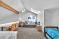 Your bright loft suite combines comfort and space with exposed beams, skylight views, and separate living and sleeping areas.