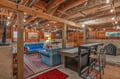 Unwind in your cozy basement retreat with exposed beams, comfortable seating, and games for memorable evenings with family.
