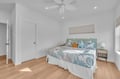 Drift off in this coastal-themed bedroom where ocean-inspired linens and warm wood floors create your perfect seaside retreat.