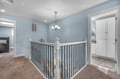 Bright upstairs landing with soothing blue walls creates a welcoming transition between your private spaces and shared areas.