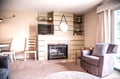 Relax by the fireplace in your cozy living room, where soft seating and warm lighting create the perfect space to unwind after a day of adventure.