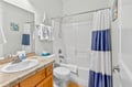 Step into your sparkling clean bathroom featuring fresh towels and nautical touches that make you feel right at home.