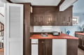 Cook your favorite meals in this charming kitchen with terra cotta tile counters and vintage wood cabinets.