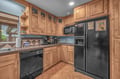 Your fully equipped kitchen features warm wood cabinetry, modern appliances, and ample counter space—perfect for preparing homemade meals during your stay.