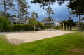Challenge friends to beach volleyball on this pristine sand court, surrounded by charming coastal homes and towering pines.