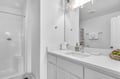 Your pristine bathroom features bright vanity lighting, plush towels, and a spacious shower—perfect for refreshing after your adventures.