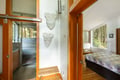 Your contemporary retreat features warm wood accents and artistic touches, with a sleek kitchen and peaceful bedroom overlooking the forest.