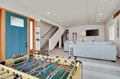 Challenge friends to foosball while relaxing in your bright, modern living space with cozy seating and entertainment setup.