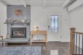 Cozy up by your crackling fireplace in this charming living space with exposed beams and thoughtful coastal touches.
