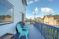 Settle into your private balcony with bright Adirondack chairs and soak in the neighborhood views—perfect for morning coffee or unwinding after a day of exploring.