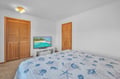 Drift off to sleep under soft coastal-themed bedding while your favorite shows play on the flat-screen TV in this peaceful bedroom retreat.