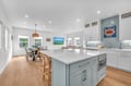 Cook and entertain in your bright, modern kitchen featuring a spacious island, coastal-inspired blue accents, and seamless flow to the dining area.