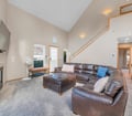 Sink into plush leather seating beneath soaring vaulted ceilings. Bright natural light fills your loft-style retreat, creating an airy escape where you can truly unwind.