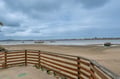 This coastal property offers beachside access with sandy shores and calm bay waters, surrounded by natural coastal landscapes and distant shoreline views.