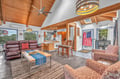 Relax in your spacious open-concept living space with soaring wood beams, comfortable seating, and a fully equipped kitchen perfect for gathering.