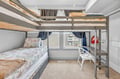 Your cozy bunk room features comfortable beds with soft linens and a charming window view of the neighborhood.