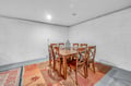Gather around your private dining table for memorable meals together in this spacious room featuring warm wood furniture and colorful decor.