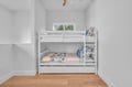 Your kids will love this cozy bunk bed area with cheerful ocean-themed bedding and bright natural light streaming through the window.