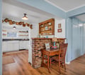Main Cottage: Dining nook, brick detail, and kitchen.