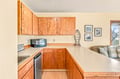 Your cozy kitchenette features warm wood cabinetry and plenty of counter space for preparing your favorite meals.