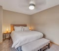 Settle into this cozy bedroom where soft lighting and plush linens create your peaceful retreat after a day of adventure.
