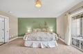 Drift off in your serene coastal bedroom with its calming sage accent wall and inspiring 'Be Free' message above the plush bed.