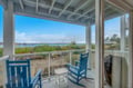 Relax in your charming blue rocking chairs while gazing at peaceful water views from your covered porch.