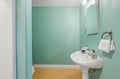 Refresh in your private bathroom with soft mint walls, warm wood floors, and a sparkling pedestal sink stocked with fresh towels and thoughtful toiletries just for you.