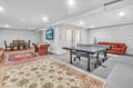 Your private game room awaits with ping pong, pool table, and cozy seating for endless entertainment.