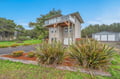 A modern coastal retreat nestled among evergreens with a spacious garage, perfect for a peaceful Oregon coast getaway.