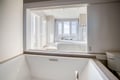 Luxurious ensuite with soaking tub overlooking your private bedroom - pure relaxation awaits.