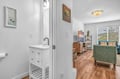 Your bright living space flows seamlessly from cozy seating to convenient vanity area, with warm wood floors and thoughtful touches throughout.