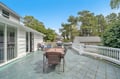 Enjoy alfresco dining on your private terrace, surrounded by lush trees and peaceful neighborhood charm.