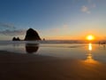 A stunning coastal sunset illuminates dramatic sea stacks and sandy beach, showcasing the natural beauty surrounding the property area.