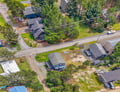 Aerial view showcasing the property nestled in a peaceful residential neighborhood with tree-lined streets and local charm.