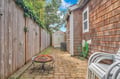 Cozy backyard retreat with fire pit for evening gatherings and brick patio perfect for morning coffee or sunset relaxation.