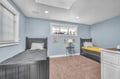 Your kids will love this charming twin bedroom with nautical touches, cozy carpet for playtime, and cheerful coastal decor.