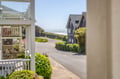 This coastal neighborhood features charming shingle-style homes just steps from the ocean, with lush greenery framing quiet streets that lead to the waterfront.